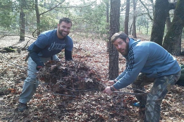 Texas students gathering debris for a leaf hut"