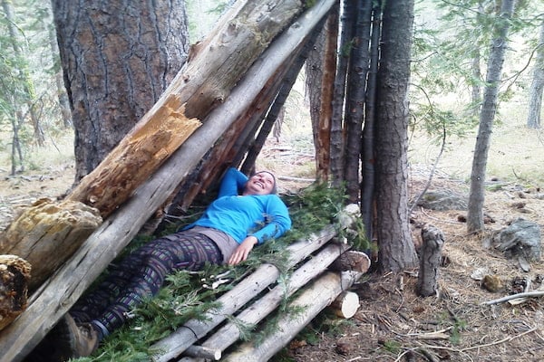 advanced woman student posing in survival shelter."